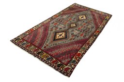 Corner detail of 2000s Persian Gabbeh rug showing border pattern and Wool pile