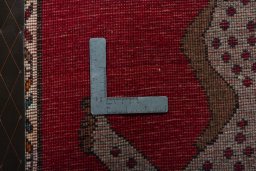 Corner detail of 2000s Persian Gabbeh rug showing border pattern and Wool pile