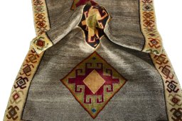 Corner detail of 2000s Persian Gabbeh rug showing border pattern and Wool pile