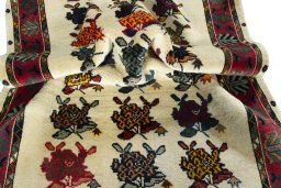 Corner detail of 2000s Persian Gabbeh rug showing border pattern and Wool pile