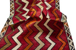 Corner detail of 2000s Persian Gabbeh rug showing border pattern and Wool pile