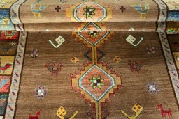 Full view of 2000s Persian Gabbeh rug from Iran / Persia, 238 × 135 cm in Brown tones