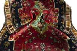 Corner detail of 2000s Persian Gabbeh rug showing border pattern and Wool pile