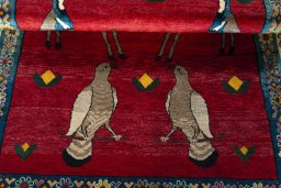 Full view of 2000s Persian Gabbeh rug from Iran / Persia, 202 × 128 cm in Red tones