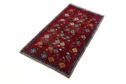 Corner detail of 2000s Persian Gabbeh rug showing border pattern and Wool pile