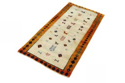 Corner detail of 2000s Persian Gabbeh rug showing border pattern and Wool pile
