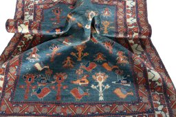 Corner detail of 2000s Persian Gabbeh rug showing border pattern and Wool pile