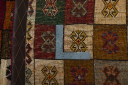 Corner detail of 2000s Persian Gabbeh rug showing border pattern and Wool pile