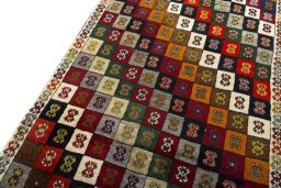 Surface texture of 2000s Persian Gabbeh rug with natural Wool and intricate pattern