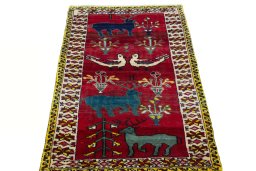 Surface texture of 2000s Persian Gabbeh rug with natural Wool and intricate pattern
