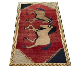 Surface texture of 2000s Persian Gabbeh rug with natural Wool and intricate pattern