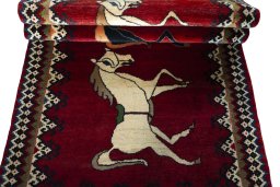 Corner detail of 2000s Persian Gabbeh rug showing border pattern and Wool pile