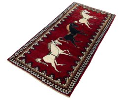 Corner detail of 2000s Persian Gabbeh rug showing border pattern and Wool pile