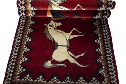 Full view of 2000s Persian Gabbeh rug from Iran / Persia, 218 × 110 cm in Red tones