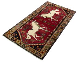 Corner detail of 2000s Persian Gabbeh rug showing border pattern and Wool pile
