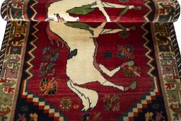 Full view of 2000s Persian Gabbeh rug from Iran / Persia, 217 × 114 cm in Red tones