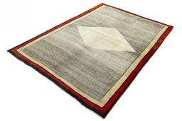 Corner detail of 2000s Persian Gabbeh rug showing border pattern and Wool pile