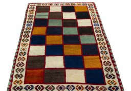 Surface texture of 2000s Persian Gabbeh rug with natural Wool and intricate pattern