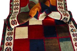 Corner detail of 2000s Persian Gabbeh rug showing border pattern and Wool pile
