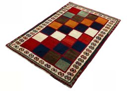 Corner detail of 2000s Persian Gabbeh rug showing border pattern and Wool pile