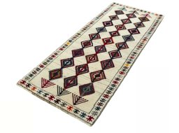 Corner detail of 2000s Persian Gabbeh rug showing border pattern and Wool pile
