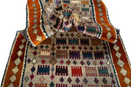 Corner detail of 2000s Persian Gabbeh rug showing border pattern and Wool pile
