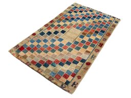 Corner detail of 2000s Persian Gabbeh rug showing border pattern and Wool pile