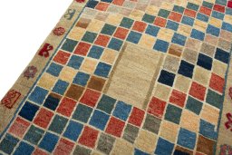 Backside of handmade 2000s Persian Gabbeh rug showing knot structure and weave density