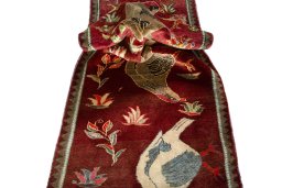 Corner detail of 2000s Persian Gabbeh rug showing border pattern and Wool pile