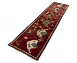Corner detail of 2000s Persian Gabbeh rug showing border pattern and Wool pile