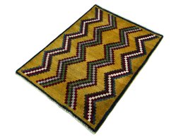 Corner detail of 2000s Persian Gabbeh rug showing border pattern and Wool pile