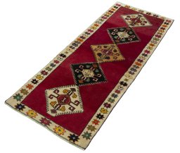 Corner detail of 2000s Persian Gabbeh rug showing border pattern and Wool pile