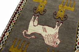 Backside of handmade 2000s Persian Gabbeh rug showing knot structure and weave density