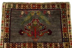 Surface texture of 2000s Persian Gabbeh rug with natural Wool and intricate pattern