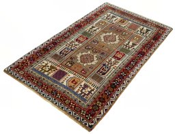 Corner detail of 2000s Persian Gabbeh rug showing border pattern and Wool pile