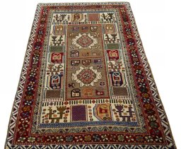 Surface texture of 2000s Persian Gabbeh rug with natural Wool and intricate pattern