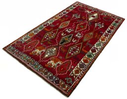Corner detail of 2000s Persian Gabbeh rug showing border pattern and Wool pile