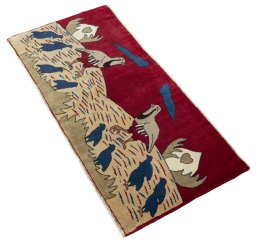 Corner detail of 2000s Persian Gabbeh rug showing border pattern and Wool pile