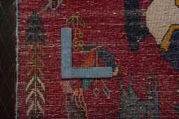 Backside of handmade 2000s Persian Gabbeh rug showing knot structure and weave density