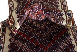 Corner detail of 2000s Persian Gabbeh rug showing border pattern and Wool pile