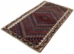 Corner detail of 2000s Persian Gabbeh rug showing border pattern and Wool pile