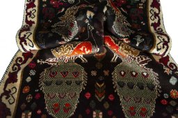 Corner detail of 2000s Persian Gabbeh rug showing border pattern and Wool pile