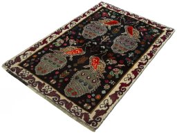 Corner detail of 2000s Persian Gabbeh rug showing border pattern and Wool pile