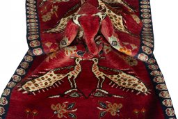 Corner detail of 2000s Persian Gabbeh rug showing border pattern and Wool pile
