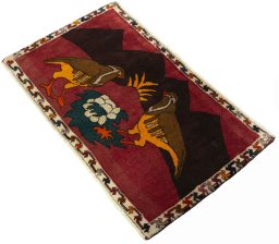Corner detail of 2000s Persian Gabbeh rug showing border pattern and Wool pile