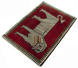 Corner detail of 2000s Persian Gabbeh rug showing border pattern and Wool pile