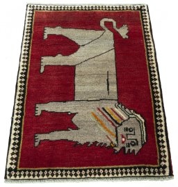 Surface texture of 2000s Persian Gabbeh rug with natural Wool and intricate pattern