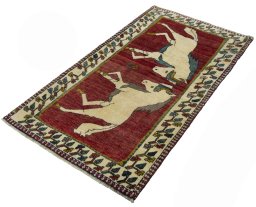 Corner detail of 2000s Persian Gabbeh rug showing border pattern and Wool pile