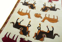 Backside of handmade 2000s Persian Gabbeh rug showing knot structure and weave density