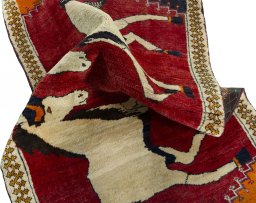 Corner detail of 2000s Persian Gabbeh rug showing border pattern and Wool pile